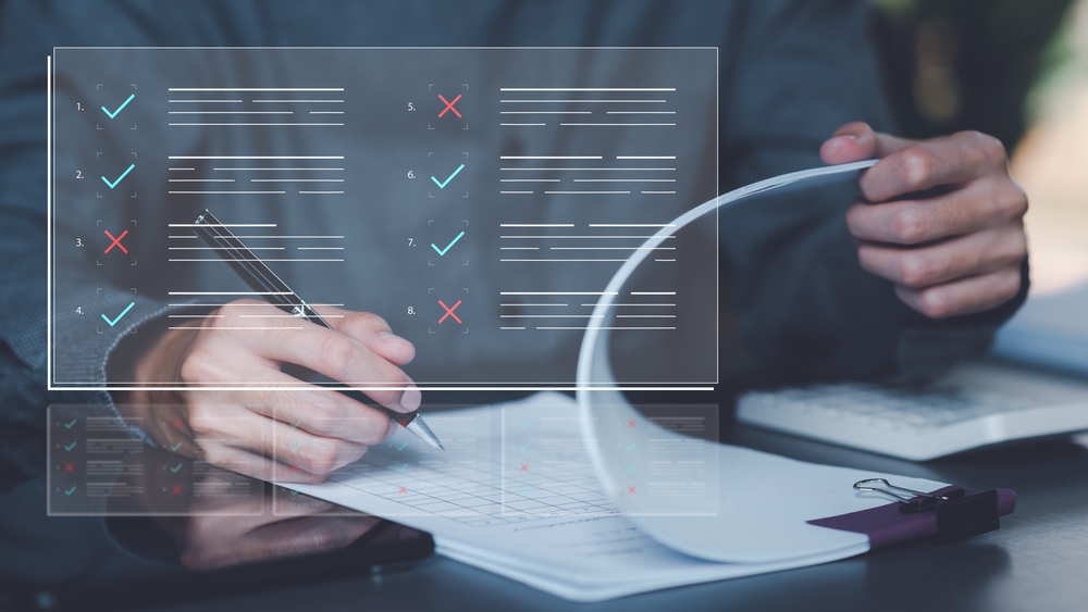 image_Businessman,Checking,The,Steps,Through,Document,With,A,List,Of