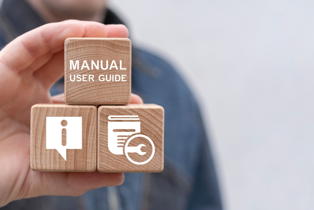 image_Man,Holding,Wooden,Cubes,Sees,Inscription:,Manual,User,Guide.,Concept