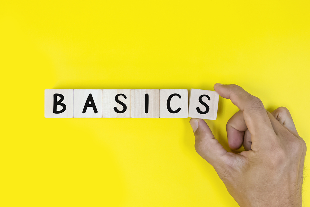 image_Male,Hand,Holding,Wooden,Cubes,With,The,Word,Basics.,Business