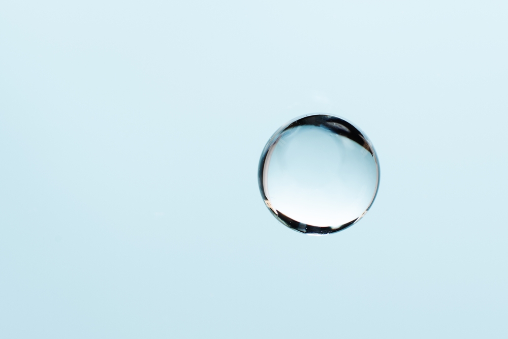 image_Collagen,Drop,On,Blue,Background,With,Copy,Space.,Abstract,Blue