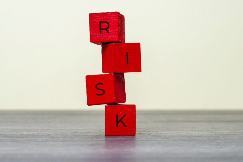 image_Red,Wooden,Blocks,Precariously,Stacked,With,The,Word,Risk.,Danger,